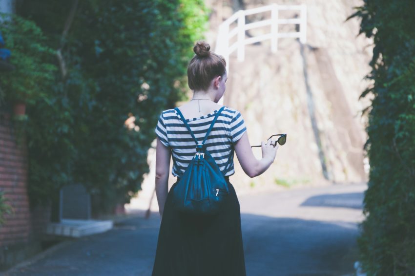 A woman wearing striped fashion essentials, mainly a shirt.